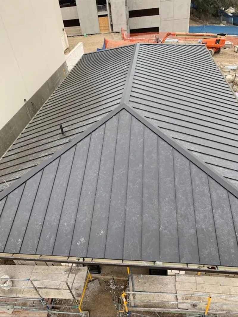 Commercial metal roof construction with crane equipment in Batesville